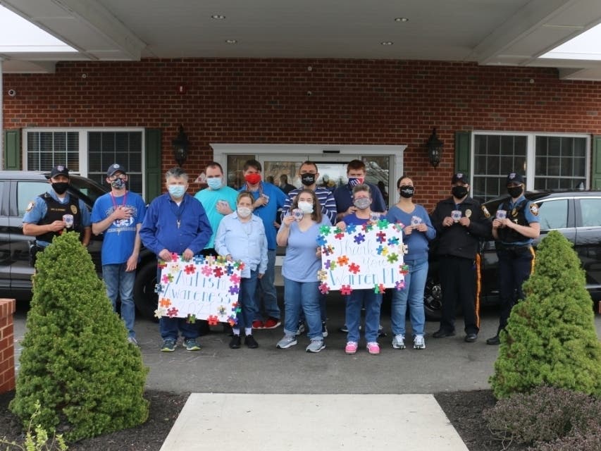 Warren Township Police Officers Robert Apisa, Angelo Barbieri, and Victoria Ciampa with residents and staff from Mt. Bethel Village.
