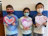 Central School Grade 1 students from Mrs. Deshields' class Craig Riegel, Lily Mungekar,
Leo Cheng are all smiles with their special Valentines for Veterans.