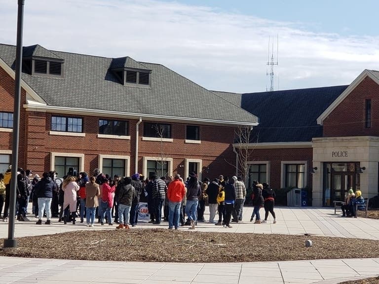 A large number of people gathered to protest against racial disparity in front of the Bridgewater Police station on Saturday afternoon following the handling of a teen mall fight.