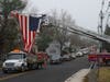 Superior Towing's flatbed truck carries Seth Newton's casket beneath an American flag that is held aloft by Lebanon Ladder Truck 18 and Annadale Hose Company's Tower 46 on Cokesbury Road in Lebanon.
