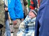 An elderly gentleman being wheeled across the border into Poland from Ukraine in a wheelchair.