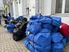 Suitcases and duffle bags with OTC meds being delivered to JDC distribution center at Nosyk Synagogue in Warsaw.