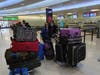 Ellen and Robin with 11 suitcases filled with OTC meds collected from the community weighing more than 400 pounds.