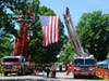 People entering the festival are seen passing beneath an American flag held aloft by Readington and North Branch fire trucks.