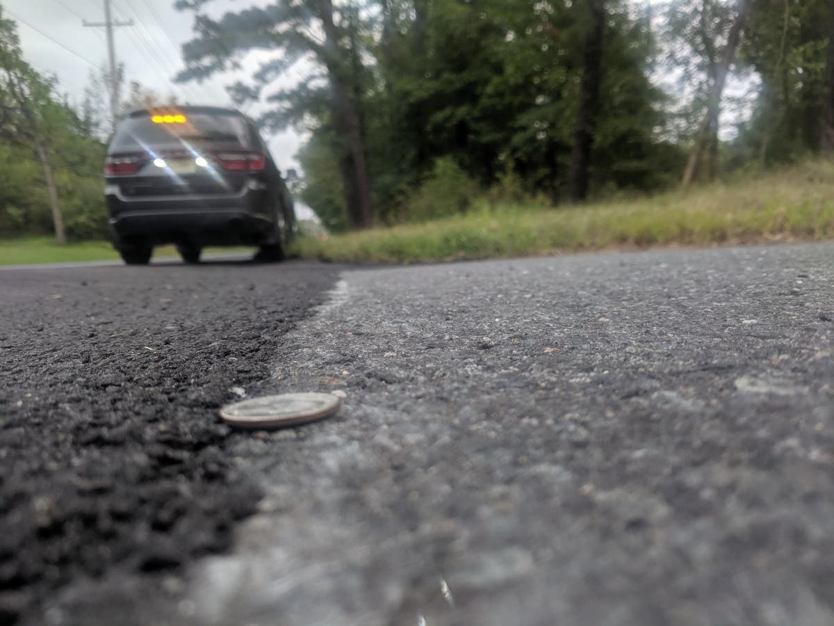 The slurry seal coating is roughly the height of a quarter on its side, but extends the usable life of a roadway by as much as five years at significantly lower cost than milling and paving.