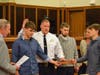 John Mitzak being sworn in by Mayor Matthew Monech and surrounded by his family.