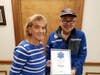 President Phil Lai-Len presents Charlotte Flohl a certificate recognizing her 47 years service to the Liberty Corner First Aid Squad.