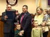 Mayor Shawn Lipani swearing in Robert Britting with his family.