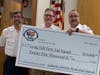 President Greg Taylor presenting check to Lt Jim Dellureficio and President Scott Orshan of the Long Hill First Aid Squad.