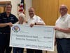 President Greg Taylor & Vice President Don Hart presenting check to Chief George Nowskoski and President Joanne Bixler of the Martinsville Rescue Squad.