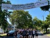 Ridge High School Drama Club standing under a banner recognizing their achievements.