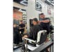 Andre Heredia cutting hair at the babershop.