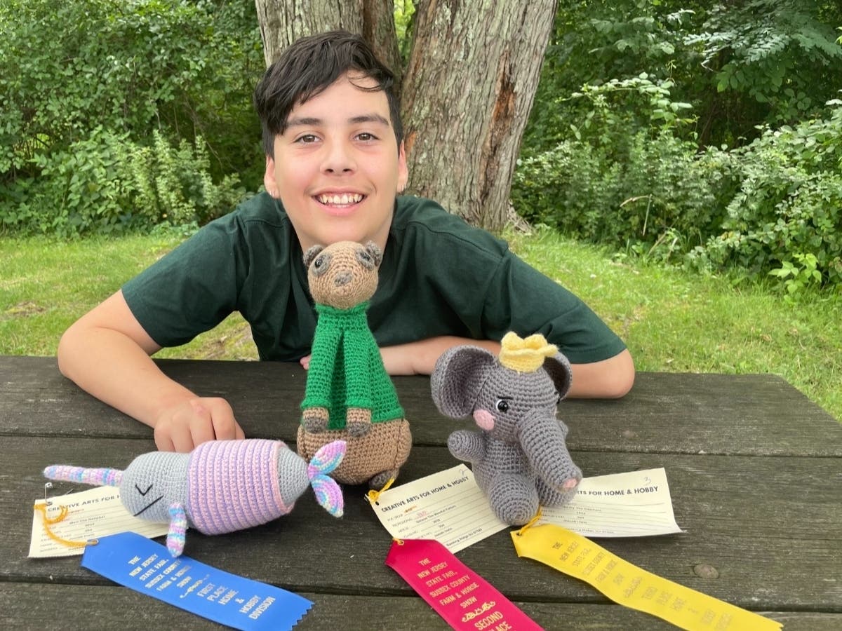 Josiah Irwin, 12, of Basking Ridge with his crochet items and ribbons.