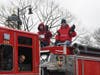 Country Hills FD members wave to the crowd standing curbside.