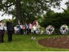 Two members of Bradley Gardens Rescue Squad salute the flag after laying a wreath to pay their respects.