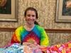 Simone Rudich, Activity Director, NJ Eastern Star Nursing Home, accepts the blankets created and donated by the GCI delegates. 