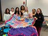 Members of the Bridgewater Juniorette Club and four  BRHS delegates to the Girls Career Institute  display  blankets created at the June event at Douglass College. The blankets were then donated to a local nursing home.