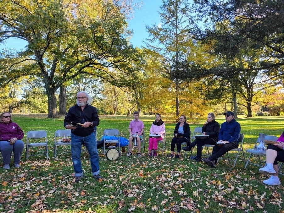 Dana McCurdy gives drumming instructions to participants of the 2023 “Drumming in the Garden” in Colonial Park.
