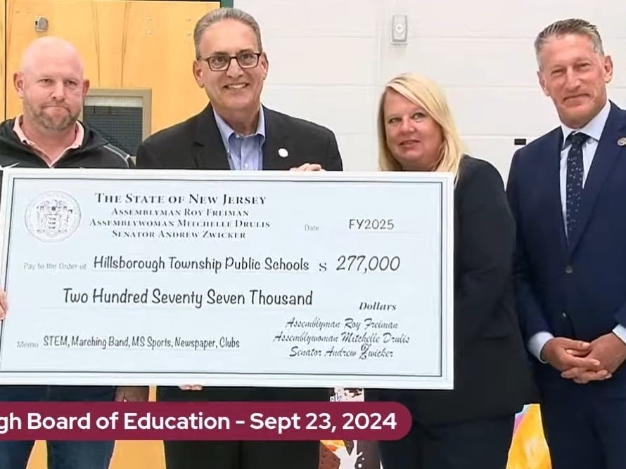 Board of Education President Paul Marini accepted the check from Senator Andrew Zwicker, Assemblyman Roy Freiman, and Assemblywoman Michelle Drulis.