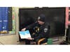 Officer Garret Stratton reading to elementary students at Rock Brook School.
