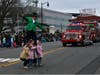Stilt Walkers pose for a photo with children along Main Street.