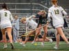 Cameron Hansen, freshman #14, wins the ground ball and gains possession.