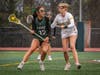 Charlotte Daniel, senior #12, dodges past a defender behind the cage.
