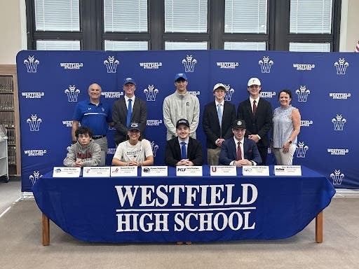 Nine Westfield High School student-athletes signed Letters of Intent with colleges and universities in April. Pictured with WHS Athletic Director James DeSarno (left) and Principal Asfendis (right).