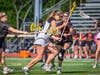 Willow Young, junior #18, splits two Somerville defenders to move the ball into Ridge's attacking edge.