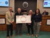 Members of the Rotary Club of Hillsborough presented Mayor Catherine Payne and members of the 250th Anniversary Planning Committee with a check for $2,400.