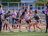 Grace Geary, sophomore #22, Bridget Nassan, senior #19, and Jojo Venable, senior #13, close in to pull the flag of a St. Thomas Aquinas ball-carrier.