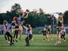 Nicole Gebert, senior #33, rises high over three St. Thomas Aquinas defenders to make the reception.