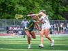 Camryn Ireland, junior #21, takes a shot at the cage under pressure.