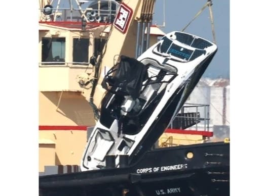 A photo of the capsized Vessel being recovered from the water.