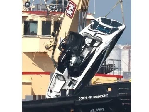 A photo of the capsized Vessel being recovered from the water.
