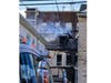 A woman is hospitalized with a broken bone after jumping from the third floor to escape a house fire on Sunday, Elizabeth officials said.