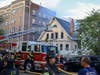 A woman is hospitalized with a broken bone after jumping from the third floor to escape a house fire on Sunday, Elizabeth officials said.