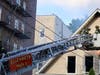A woman is hospitalized with a broken bone after jumping from the third floor to escape a house fire on Sunday, Elizabeth officials said.