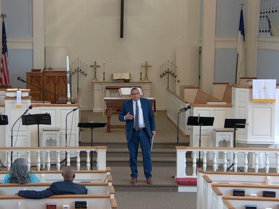 Lt. Gov. Dale Caldwell and the pastor of the Covenant United Methodist Church is seen holding a service in May 2025.