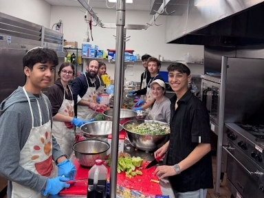 Teens chop vegetables for a Kitchen of Kindness meal in the kitchen at Chabad of Somerset County in Basking Ridge. The finished meals go to the Food Bank Network of Somerset County.