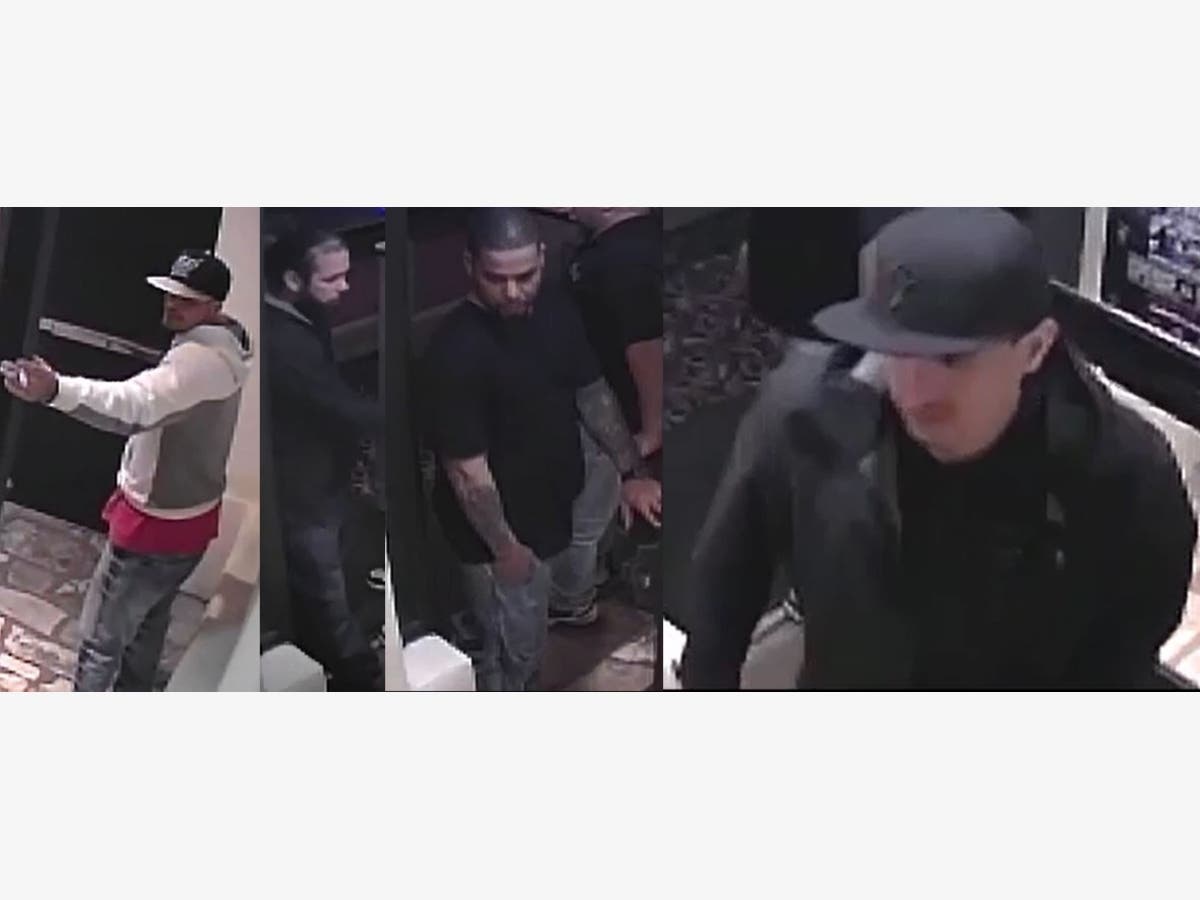 Police say four men attacked patrons of the strip club and stole a wallet from one of them before driving away.