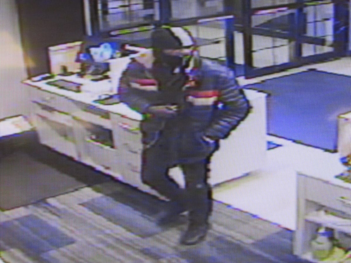 Witnesses told officers that a man wearing a mask and armed with a gun walked into the hotel lobby and demanded money.