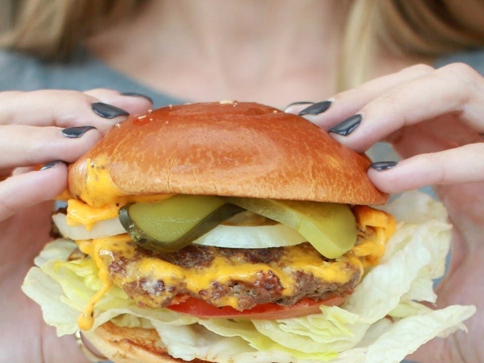 The burger joint, which caught fire in January just one day after opening, re-opened its doors on Monday.