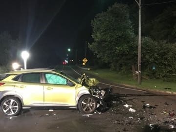A motorcycle collided with a car carrying two passengers at about 9 p.m., according to police.