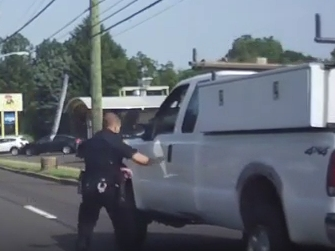 The officer on Tuesday saw the truck's passenger waving him down and that the driver appeared to be in convulsions.