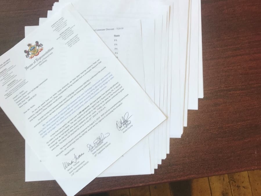 Rep. Wendi Thomas presents pages of petitions from residents demanding a discount for PA E-ZPass users on the Scudder Falls Bridge.