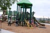 Children enjoy the revamped St. John Neighborhood Park on Wednesday.