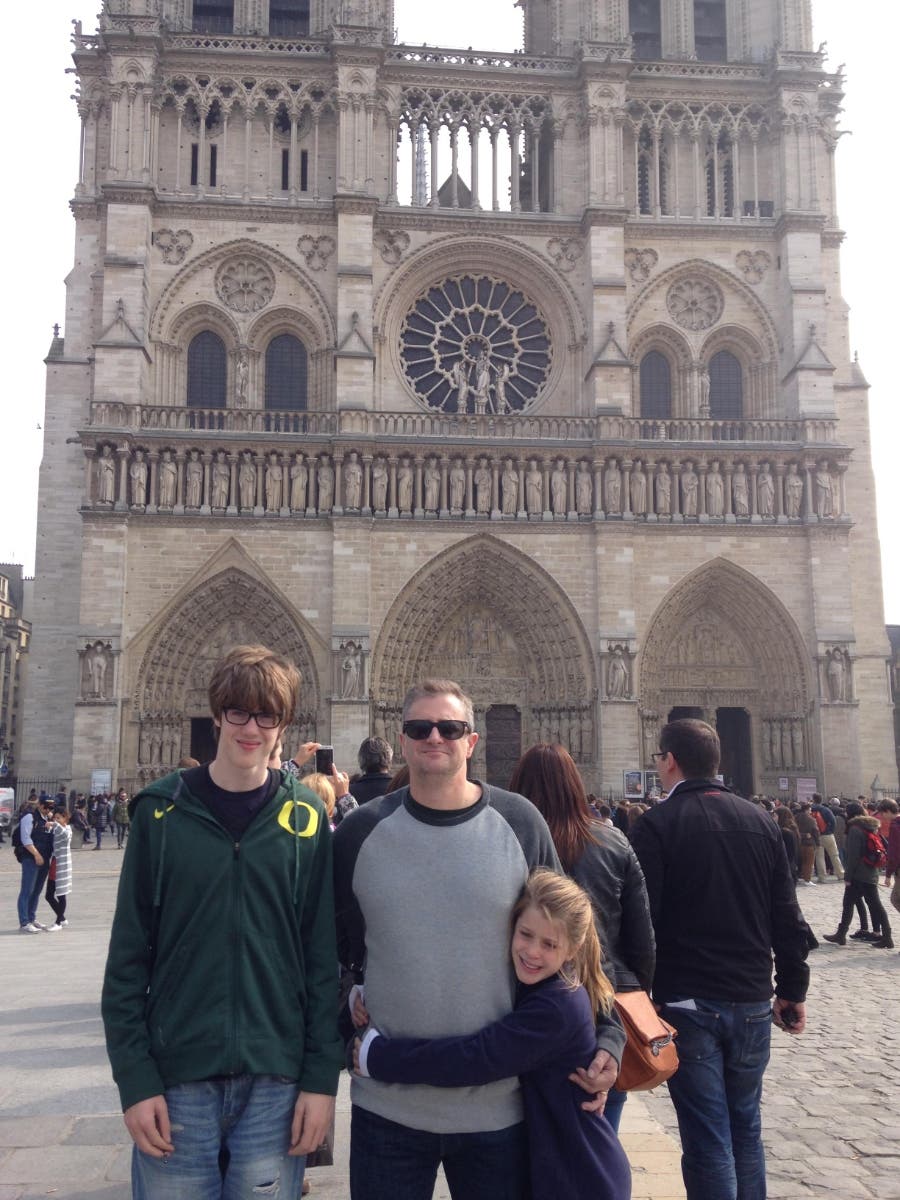 Anton Caputo is flanked by son Dante and daughter Lexi during a family trip to see Notre Dame Cathedral in 2015.