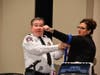 im Persons demonstrates tourniquet application on Robin Wiatrek with the Capital Area Trauma Regional Advisory Council.