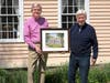 Artist Bill Dowling (right) presents painting to MHS President Mark Edmiston.